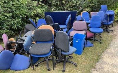 Office chairs and screens collected together for reuse