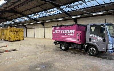 Jettison Express truck at the depot beside skips used for sorting waste
