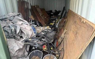 Storage container full of old boards, tools and junk