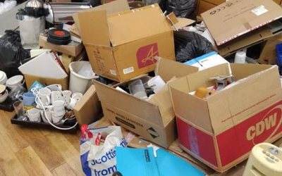 Boxes, bags, mugs and a fan heater piled up for a clear out