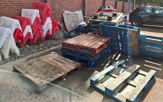 Wooden pallets and plastic barriers gathered for reuse and recycling