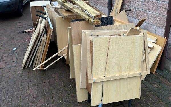 Dismantled furniture stacked outside a rented house ready for collection